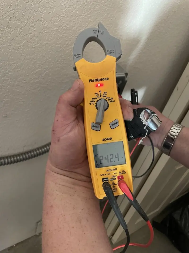 Voltage testing with clamp meter during Whole House Surge Protector in Clyde Hill